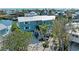 Two-story waterfront home with a metal roof, lush landscaping, and convenient canal access at 511 Loquat Dr, Anna Maria, FL 34216