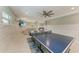 Entertaining game room with a ping pong table and a comfortable seating area at 511 Loquat Dr, Anna Maria, FL 34216