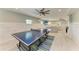 Bright game room with ping pong table and additional seating area at 511 Loquat Dr, Anna Maria, FL 34216