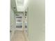 Bright hallway leading to bedrooms with white trim, light walls, and white wood floors at 511 Loquat Dr, Anna Maria, FL 34216
