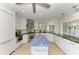 Bright kitchen featuring a unique blue island, stainless appliances and white cabinetry at 511 Loquat Dr, Anna Maria, FL 34216