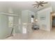 Open landing featuring light wood floors, chair, windows, and a stylish ceiling fan at 511 Loquat Dr, Anna Maria, FL 34216