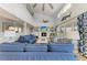 Bright, open living area with fireplace, blue furnishings, high ceilings and ample natural light at 511 Loquat Dr, Anna Maria, FL 34216