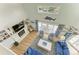 Bright living room with vaulted ceiling, nautical decor, and views of the canal at 511 Loquat Dr, Anna Maria, FL 34216