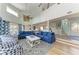 Bright, open floorplan concept with blue furnishings, hardwood floors, and ample natural light at 511 Loquat Dr, Anna Maria, FL 34216