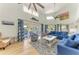 Bright, open living area with blue furnishings, high ceilings and sliding doors to the outside at 511 Loquat Dr, Anna Maria, FL 34216