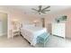 Comfortable main bedroom featuring light pink walls, ceiling fan, and calming decor at 511 Loquat Dr, Anna Maria, FL 34216