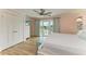 Serene main bedroom with balcony access, light pink walls, and hardwood floors at 511 Loquat Dr, Anna Maria, FL 34216