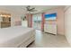 Bright main bedroom with balcony access and water views from mounted flat screen television at 511 Loquat Dr, Anna Maria, FL 34216