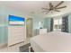 Comfortable main bedroom with aqua walls, TV, and nautical-themed decor at 511 Loquat Dr, Anna Maria, FL 34216