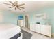 Bright and airy main bedroom with coastal decor, TV, and white wood floors at 511 Loquat Dr, Anna Maria, FL 34216
