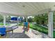 Covered outdoor area boasts a putting green, patio, and relaxing seating at 511 Loquat Dr, Anna Maria, FL 34216