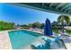 Inviting pool features in-water loungers and umbrellas, with waterfront views, and ample seating at 511 Loquat Dr, Anna Maria, FL 34216