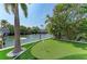 Backyard features a canal, a putting green, and an inviting outdoor space at 511 Loquat Dr, Anna Maria, FL 34216