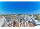 Roof deck with table and chairs has panoramic neighborhood views at 511 Loquat Dr, Anna Maria, FL 34216