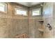 Detailed shower with custom tile, window, and convenient shelving for toiletries at 511 Loquat Dr, Anna Maria, FL 34216
