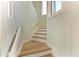 Inviting stairway with light wood treads, white risers, and fresh, light-colored walls at 511 Loquat Dr, Anna Maria, FL 34216