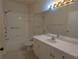 Clean, functional bathroom featuring a well-lit vanity, a tub with shower, and safety grab bars at 5168 Northridge Rd # 102, Sarasota, FL 34238