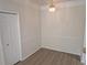 Dining area with modern chandelier, chair rail, wood-look floors, and a large closet for storage at 5168 Northridge Rd # 102, Sarasota, FL 34238