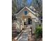 Inviting entrance to the building, featuring a covered walkway, lush landscaping, and well-maintained architecture at 5168 Northridge Rd # 102, Sarasota, FL 34238