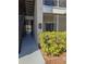 Exterior walkway of a condo building with stairs, a unit listing, and exterior trees at 5168 Northridge Rd # 102, Sarasota, FL 34238