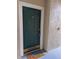 Front door of unit 102 featuring a 'Beach Please!' doormat and a secure entrance at 5168 Northridge Rd # 102, Sarasota, FL 34238