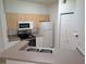 Functional kitchen with ample cabinet space, essential appliances, and a convenient breakfast bar area at 5168 Northridge Rd # 102, Sarasota, FL 34238