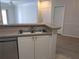 Open-concept kitchen with a double sink, dishwasher, and view to the living area at 5168 Northridge Rd # 102, Sarasota, FL 34238