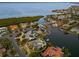 Waterfront property features lush landscaping and a private pool, near bay and mangroves at 520 Harbor Cay Dr, Longboat Key, FL 34228