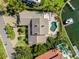 Luxury waterfront home showcasing a private pool, boat dock, lush landscaping, and paver driveway at 520 Harbor Cay Dr, Longboat Key, FL 34228