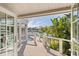 Beautiful home balcony overlooking waterfront with lush tropical landscaping and waterfront views at 520 Harbor Cay Dr, Longboat Key, FL 34228