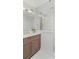 Modern bathroom featuring a frameless glass shower and wood cabinet at 520 Harbor Cay Dr, Longboat Key, FL 34228