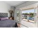 Bedroom with waterfront views, balcony access, and a cozy tufted headboard creates an inviting space at 520 Harbor Cay Dr, Longboat Key, FL 34228