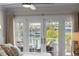 Bedroom featuring French doors, water view, and comfortable patio seating at 520 Harbor Cay Dr, Longboat Key, FL 34228