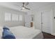 Bright bedroom leads to bathroom; features white shutters and ceiling fan at 520 Harbor Cay Dr, Longboat Key, FL 34228