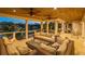 Evening view of the spacious covered lanai with cozy seating and a modern fire pit at 520 Harbor Cay Dr, Longboat Key, FL 34228