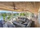 Spacious covered lanai features comfortable seating, a fire pit, and panoramic waterfront views at 520 Harbor Cay Dr, Longboat Key, FL 34228