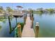 Waterfront home featuring a private boat dock with lift and direct access to the open waters at 520 Harbor Cay Dr, Longboat Key, FL 34228