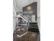 Grand foyer with marble floors, a soaring ceiling, modern chandelier, and a sweeping staircase with iron railings at 520 Harbor Cay Dr, Longboat Key, FL 34228