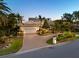 Inviting home exterior featuring a paver driveway, mature landscaping, and a two-car garage at 520 Harbor Cay Dr, Longboat Key, FL 34228