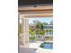 Covered lanai overlooks pool and a serene waterfront view with a boat lift at 520 Harbor Cay Dr, Longboat Key, FL 34228