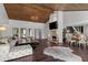 Open-concept living room with hardwood floors, fireplace, and access to the dining area for seamless entertaining at 520 Harbor Cay Dr, Longboat Key, FL 34228