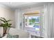Bright living room view showcases open access to a lanai, pool, and waterfront with dock at 520 Harbor Cay Dr, Longboat Key, FL 34228