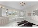 Luxurious main bathroom with marble accents, a soaking tub, walk-in shower, and stylish fixtures at 520 Harbor Cay Dr, Longboat Key, FL 34228