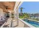 Patio with outdoor seating overlooking a swimming pool and waterfront at 520 Harbor Cay Dr, Longboat Key, FL 34228