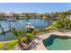 Aerial view of a waterfront home with a private pool and dock, offering luxurious outdoor living at 520 Harbor Cay Dr, Longboat Key, FL 34228