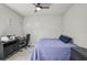 Bedroom featuring neutral decor, a ceiling fan, desk with computer and a bed with blue bedding at 5750 Long Shore Loop, Sarasota, FL 34238