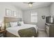 Bedroom featuring a wooden bed, soft lighting, and neutral decor at 5750 Long Shore Loop, Sarasota, FL 34238