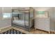 Cozy bedroom featuring a gray bunk bed, dresser, and stylish decor at 6136 Hollywood Blvd, Sarasota, FL 34231