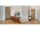 Inviting home entry features stylish wood-look tile flooring and a decorative wood dresser with modern decor at 6136 Hollywood Blvd, Sarasota, FL 34231
